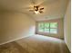 Bright bedroom with vaulted ceiling, ceiling fan, and a large window overlooking the backyard at 655 Wellingborough Ct, Alpharetta, GA 30005