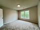Neutral bedroom featuring carpet, window, and a ceiling light at 655 Wellingborough Ct, Alpharetta, GA 30005