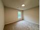Neutral bedroom featuring carpet, window, and base trim at 655 Wellingborough Ct, Alpharetta, GA 30005