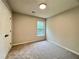 Neutral bedroom featuring carpet, window, base trim, and a closet at 655 Wellingborough Ct, Alpharetta, GA 30005