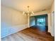 Formal dining room featuring wood floors, elegant wainscoting, and a chandelier at 655 Wellingborough Ct, Alpharetta, GA 30005