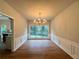 Elegant dining room with hardwood floors, wainscoting, and a chandelier at 655 Wellingborough Ct, Alpharetta, GA 30005