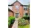 Inviting entryway featuring a brick facade, manicured landscaping, and a welcoming front door at 655 Wellingborough Ct, Alpharetta, GA 30005