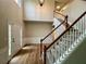 Welcoming foyer with hardwood floors, staircase, and elegant trim work at 655 Wellingborough Ct, Alpharetta, GA 30005
