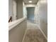 Upstairs hallway with carpeted floor and view of an open bedroom at 655 Wellingborough Ct, Alpharetta, GA 30005