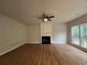 Spacious living room featuring new floors, fireplace, and large windows at 655 Wellingborough Ct, Alpharetta, GA 30005