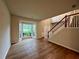 Spacious living room featuring hardwood floors, a bay window, and staircase at 655 Wellingborough Ct, Alpharetta, GA 30005