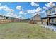 Expansive backyard with a fire pit, lush lawn, and fence, perfect for outdoor entertaining and relaxation at 1603 Maston Rd, Auburn, GA 30011