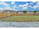 Fenced backyard with a well-manicured lawn and hardscaped patio area with stone walkway at 1603 Maston Rd, Auburn, GA 30011