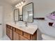Bright bathroom featuring double sinks with modern fixtures and unique rectangular mirrors at 1603 Maston Rd, Auburn, GA 30011