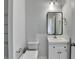 Clean bathroom featuring modern fixtures, a vanity with storage, and a sleek mirror at 1603 Maston Rd, Auburn, GA 30011