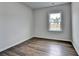 Cozy bedroom with hardwood floors and a window; a simple and comfortable space for relaxation at 1603 Maston Rd, Auburn, GA 30011