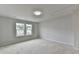 Bedroom with large windows offering backyard views, neutral walls, hardwood floors, and natural light at 1603 Maston Rd, Auburn, GA 30011
