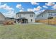 Rear exterior of the home showcasing a spacious backyard, patio area, and well-manicured lawn at 1603 Maston Rd, Auburn, GA 30011