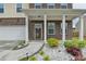 Inviting front porch with brick detailing and landscaped garden, creating a warm welcome to the home at 1603 Maston Rd, Auburn, GA 30011