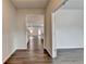 Hallway with hardwood floors leading into a spacious kitchen, creating a seamless flow between rooms at 1603 Maston Rd, Auburn, GA 30011