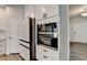 Modern kitchen with stainless steel oven and refrigerator, and white cabinets at 1603 Maston Rd, Auburn, GA 30011