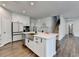 Modern kitchen featuring an island with a sink, stainless steel appliances, and white cabinets at 1603 Maston Rd, Auburn, GA 30011