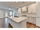 Open concept kitchen with a large island, stainless steel sink and a black faucet at 1603 Maston Rd, Auburn, GA 30011