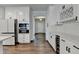 Modern kitchen with stainless steel appliances, wine rack, and white cabinetry at 1603 Maston Rd, Auburn, GA 30011