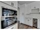 Modern kitchen features stainless steel appliances, white cabinets, and beverage cooler at 1603 Maston Rd, Auburn, GA 30011