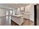 Bright, modern kitchen with white cabinets, a large island, and stainless steel appliances at 1603 Maston Rd, Auburn, GA 30011