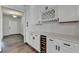 Kitchen bar area featuring white cabinets, wine rack, beverage cooler, and countertops at 1603 Maston Rd, Auburn, GA 30011