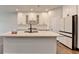 Bright kitchen features a large island with white countertops and modern appliances at 1603 Maston Rd, Auburn, GA 30011