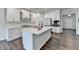 Bright kitchen features white cabinets, stainless appliances, and a large center island, perfect for cooking and entertaining at 1603 Maston Rd, Auburn, GA 30011