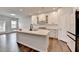 Modern kitchen featuring a large island, white cabinetry, and seamless flow into the living area at 1603 Maston Rd, Auburn, GA 30011