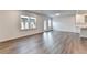 Open floor plan with hardwood floors and large windows; living room with access to the kitchen and outdoor space at 1603 Maston Rd, Auburn, GA 30011
