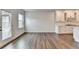 Open-concept living space with hardwood floors, lots of natural light, a patio door, and direct access to the kitchen at 1603 Maston Rd, Auburn, GA 30011