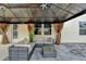 Inviting outdoor lounge area with a covered gazebo, comfortable seating, and stylish curtains for privacy and shade at 1603 Maston Rd, Auburn, GA 30011