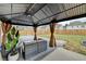 Outdoor patio with a covered gazebo, seating area, and a view of the fenced backyard at 1603 Maston Rd, Auburn, GA 30011