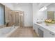 Well-appointed bathroom with a separate shower, bathtub, and dual sinks at 1783 Drew Nw Dr, Atlanta, GA 30318