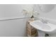 Charming bathroom with pedestal sink, flower accent and white wainscoting at 1783 Drew Nw Dr, Atlanta, GA 30318