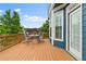 Outdoor deck ideal for relaxing with a table and chairs and a view of lush greenery at 1783 Drew Nw Dr, Atlanta, GA 30318