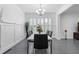 Elegant dining room featuring modern table, black chairs, wainscoting, and bright light fixture at 1783 Drew Nw Dr, Atlanta, GA 30318