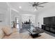 Inviting living room with open layout, modern ceiling fan, and adjacent dining area at 1783 Drew Nw Dr, Atlanta, GA 30318