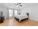 Spacious main bedroom boasts hardwood floors, a ceiling fan, and bright, natural light at 1783 Drew Nw Dr, Atlanta, GA 30318