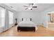Bright and airy main bedroom with hardwood floors, ceiling fan, and en suite bathroom access at 1783 Drew Nw Dr, Atlanta, GA 30318