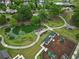 Aerial view of the community park highlighting walking path, playground, and green spaces surrounded by trees at 1783 Drew Nw Dr, Atlanta, GA 30318