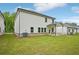 Green backyard with a covered patio, perfect for outdoor entertaining at 3970 Brushy St, Powder Springs, GA 30127