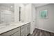 Modern bathroom with double vanity, quartz countertops, wood-look tile flooring, and ample storage at 3970 Brushy St, Powder Springs, GA 30127