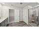 Modern bathroom featuring tiled shower and access to bedroom at 3970 Brushy St, Powder Springs, GA 30127