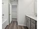 Clean bathroom features a shower-tub, single sink with quartz countertop, and plank flooring at 3970 Brushy St, Powder Springs, GA 30127