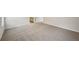 Open bedroom with gray carpet leading to the bathroom at 3970 Brushy St, Powder Springs, GA 30127