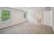 Large carpeted bedroom with windows and walk-in closet access at 3970 Brushy St, Powder Springs, GA 30127