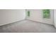 Well lit bedroom featuring soft gray carpeting and dual windows at 3970 Brushy St, Powder Springs, GA 30127