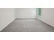 Bright bedroom featuring a window and soft gray carpeting at 3970 Brushy St, Powder Springs, GA 30127
